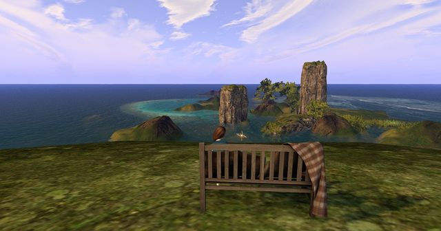 The bench on the cliff above Long Lake, a blanket over its arm, the sea stacks beyond.